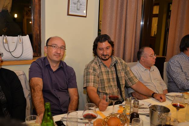 A group of people sitting at a table

Description generated with very high confidence