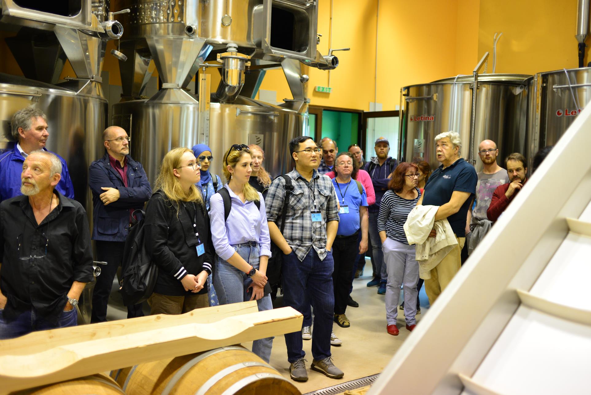 A group of people standing in a room

Description automatically generated